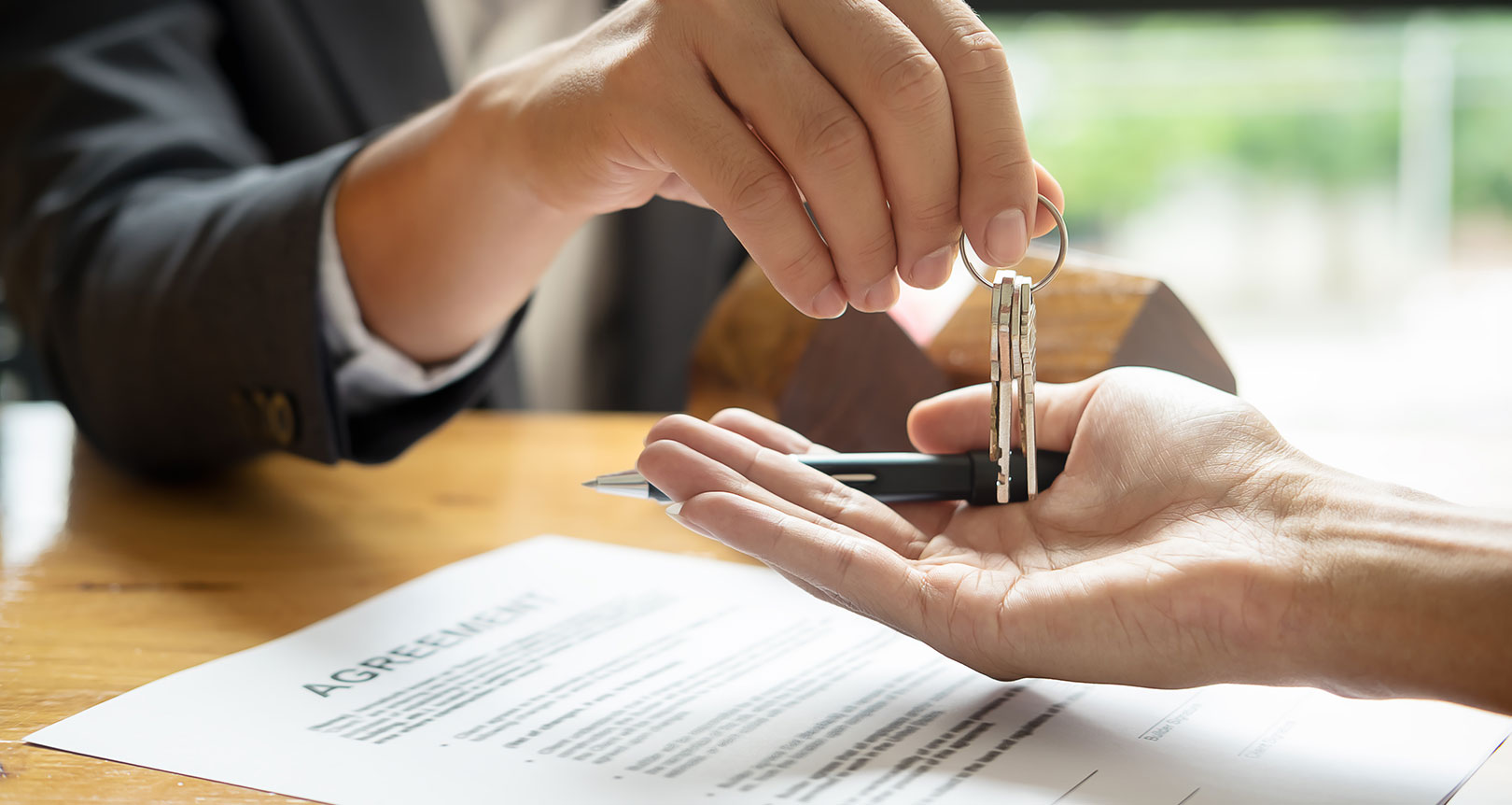 Realtor handing someone the keys to a new home